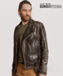 Front view of men's distressed leather bomber jacket zipped up, showcasing waist belt closure, notch collar, and functional chest pocket.