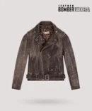 Model wears men’s brown distressed leather bomber jacket with fur collar, showing vintage finish and rugged fit in natural outdoor lighting.